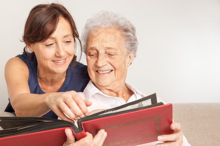 senior and daughter with book
