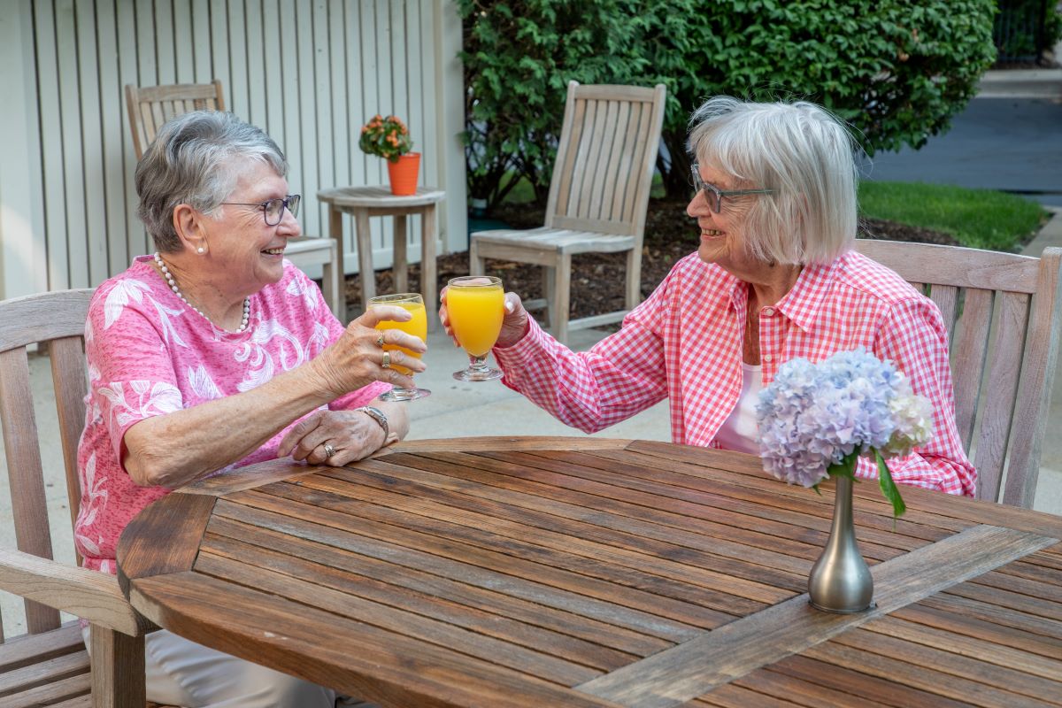 Ladies at Village at The Oaks enjoying a beverage on the patio